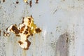 Abstract background texture of vertical grungy rusting metal plate with peeling paint and extensive corrosion with rust streaks. Royalty Free Stock Photo