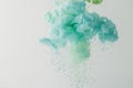 abstract background with turquoise paint flowing in water, isolated on grey