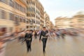 Abstract background. Two police officers walking along the streets of Rome, Italy. Radial zoom blur effect defocusing filter