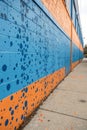 A wall with a lot of spots and a blue and orange background Royalty Free Stock Photo