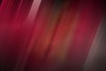 Abstract background, vertical multicolored stripes of red scale with a slope in to left and blur in the middle
