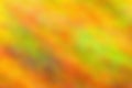 Abstract background in yellow, red, green and orange autumn colors. Blurred background for design and decor.