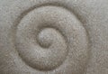 Abstract backgrounds of spiral design by hand on the white sand beach Royalty Free Stock Photo