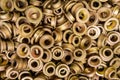 An abstract backround of yellow cadmium coated steel rings. Closeup with selective focus.