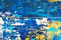 Abstract beautiful pattern of old metallic door surface painted in yellow, white and blue, background texture Royalty Free Stock Photo