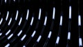 Abstract bended dark tubes with moving long lights on a black background. Design. Technological pattern with light bulbs