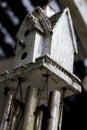Abstract bird house windchime dirty and weathered