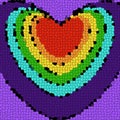 Abstract bitmap. Mosaic in the shape of hearts in the colors of the rainbow on a purple background