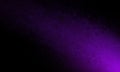 Abstract black background with bright purple color shaft of light or color splash in bottom corner