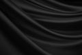 Abstract black background. Silk satin fabric. Curtain. Drapery. Luxury background for design.