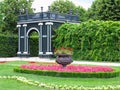 Abstract black garden arbor, flower beds and shorn trees in well-kept park Royalty Free Stock Photo