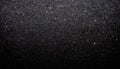 Abstract black grain texture with firefly dotwork and stipple sand effect creating a visually striking gradient background