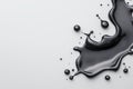 Abstract black liquid splash on a smooth white surface Royalty Free Stock Photo