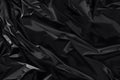 Abstract Black Plastic Film Texture Background with Wrinkled Surface and Light Reflections for Modern Clean Design Royalty Free Stock Photo