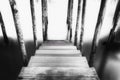 Abstract black and white picture of a wooden mooring pier and mooring piles on the Grand Canal in Venice, Italy