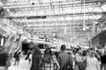 Abstract black and white view of Waterloo Station with many passengers in a rush and a clock in London, England