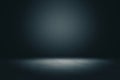 Abstract blank dark wall with copyspace and dark stage with spot light from above in empty hall