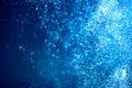 Abstract blue background with floating particles, glowing backdrop. Glitter Blinking sparks background Royalty Free Stock Photo