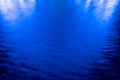 Abstract blue background, lights reflections on the water. Royalty Free Stock Photo