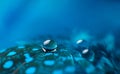 A beautiful abstract blue background with three dew drops on feather bird close up macro Royalty Free Stock Photo