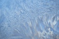 Abstract blue background. Winter frosty patterns on the window. Frozen glass texture Royalty Free Stock Photo