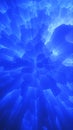 Abstract blue cracked texture emitting radiant light rays and glowing energy bursts Royalty Free Stock Photo