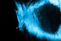 Abstract blue dust explosion on black background Royalty Free Stock Photo