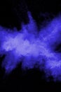 Abstract blue dust explosion on black background. Freeze motion of blue particles splashing. Painted Holi in festival Royalty Free Stock Photo