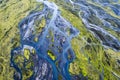 Abstract blue glacier rivers pattern flowing through volcanic moss field in Icelandic highlands on summer
