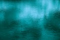 Abstract blue-green background. Reflection of sunlight on the surface of the water. Ripples. Royalty Free Stock Photo