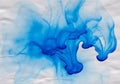 Abstract blue ink flowing over a textured white surface. The fluid Royalty Free Stock Photo
