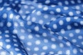 Abstract blue natural silk background. Silk fabric with polka dots pattern Royalty Free Stock Photo
