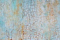 Abstract blue orange white texture with grunge cracks. Cracked paint on a metal surface. Bright urban background with rough paint