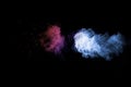 Abstract blue pink dust explosion on black background. Freeze motion of blue pink powder splash Royalty Free Stock Photo