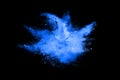 Abstract blue powder explosion on black background. Freeze motion.