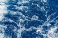 Abstract blue sea water with white waves. Blue sea texture with waves and foam. Mediterranean sea Royalty Free Stock Photo