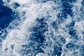 Abstract blue sea water with white waves. Blue sea texture with waves and foam. Mediterranean sea Royalty Free Stock Photo