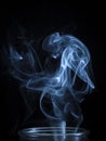 An Abstract Blue Smoke Flowing From Vertical Bottle Background