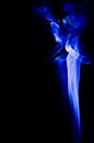 Abstract blue smoke swirls over black background Royalty Free Stock Photo