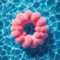 Abstract blue swimming pool water background with pink swimming pool ring float, top view Royalty Free Stock Photo