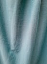 Abstract blue textured fabric background exposed to sunlight so that shadows are formed Royalty Free Stock Photo