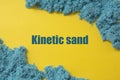 Abstract blue textured kinetic sand over yellow background. Kinetic sand word. Creativity and education concept Royalty Free Stock Photo