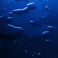 Abstract blue water drops on dark  surface Royalty Free Stock Photo