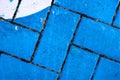 Abstract: Blue and White painted bricks with dark grout