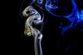 Abstract blue and yellow smoke from the aromatic sticks. Royalty Free Stock Photo