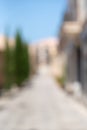 Abstract blur background of urban city in summer day, vertical. Deserted street