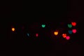 Abstract blur defocused black background, multicolored lights highlights, bokeh hearts, soft focus Royalty Free Stock Photo