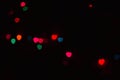 Abstract blur defocused black background, multicolored lights highlights, bokeh hearts, soft focus Royalty Free Stock Photo