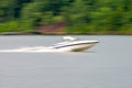 Abstract blur of nature and fast moving boat on lake