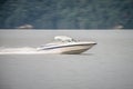 Abstract blur of nature and fast moving boat on lake